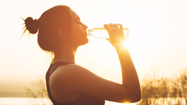 woman drinking water in the sun