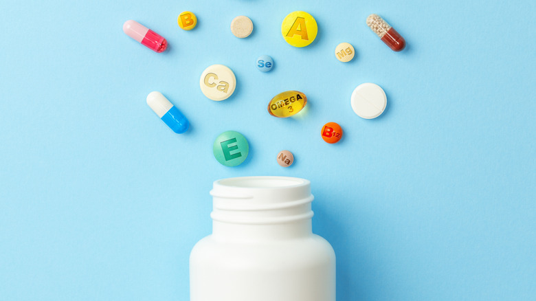 Vitamins and pills spread out in a flat lay