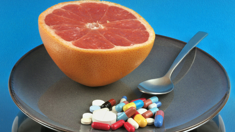 grapefruit and some medicines on a platter