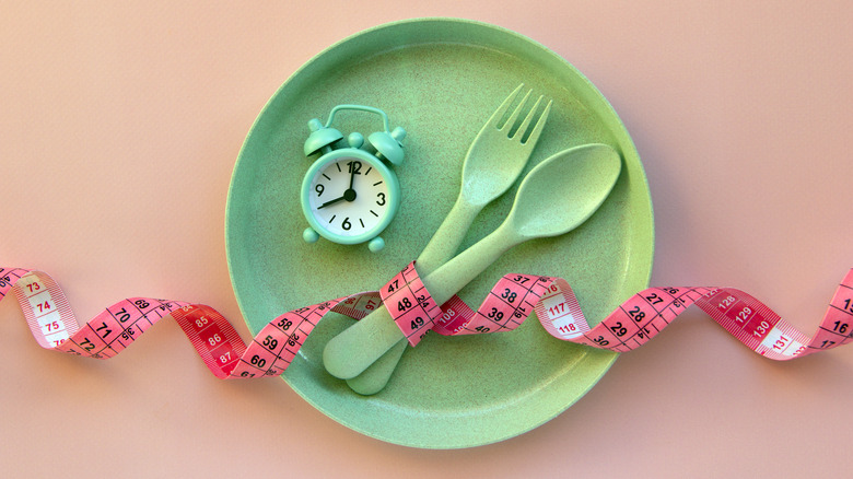 plate with a tape measure and clock