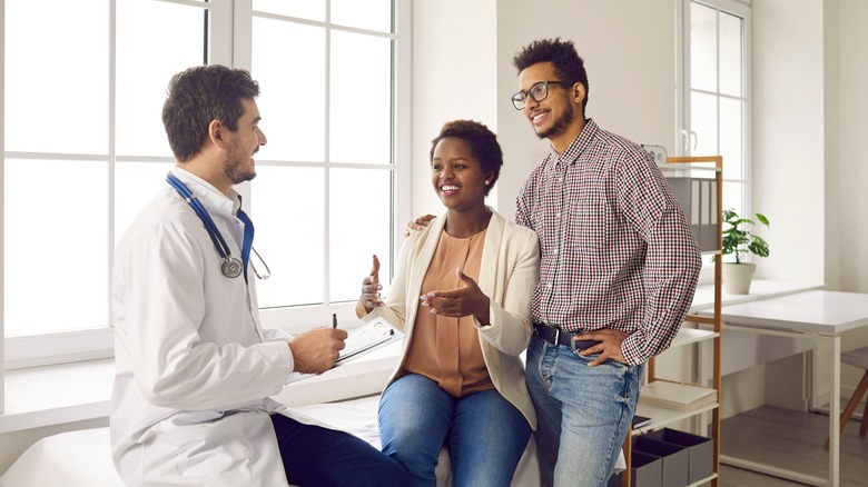 A couple speaking with a doctor 