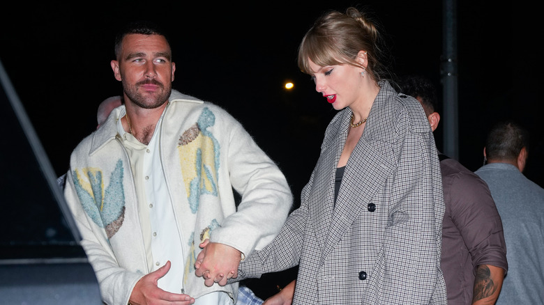 Taylor Swift and Travis Kelce holding hands