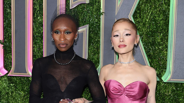 Ariana Grande and Cynthia Erivo posing together on step-and-repeat