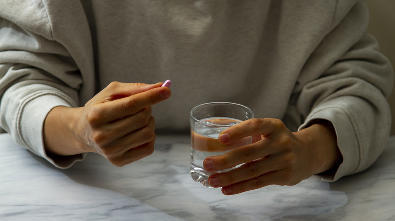 woman taking pill