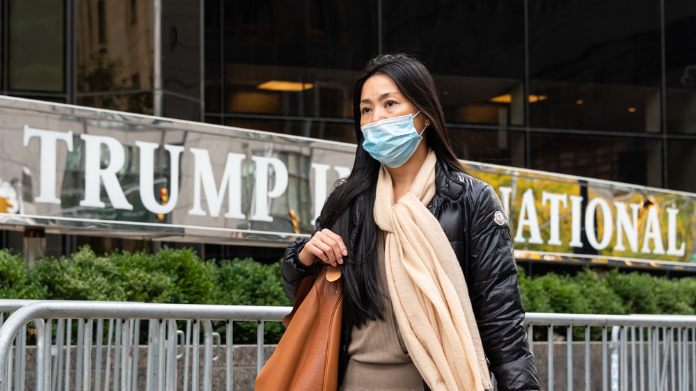 Woman wearing face mask outside Trump Organization