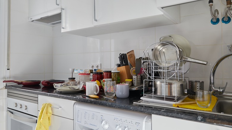 cluttered dishes on kitchen counter