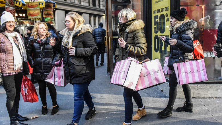 Shoppers carrying Victoria Secret Bags