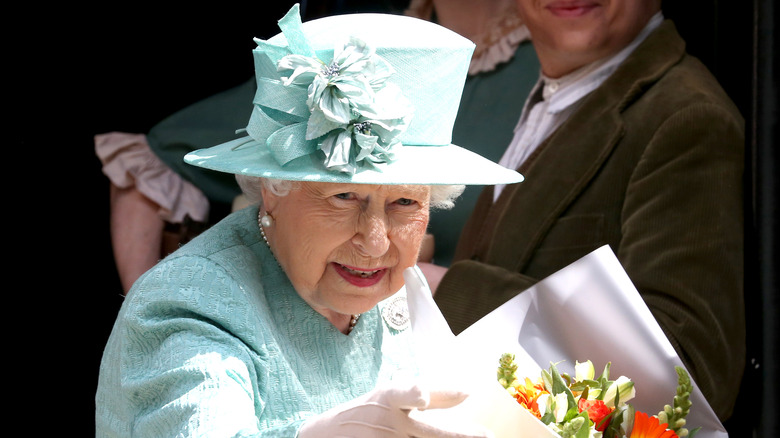 The Queen holding flowers