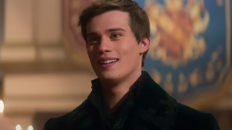 Close up of Nicholas Galitzine in black coat in Cinderella 