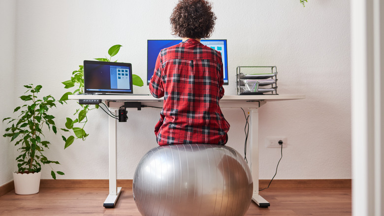 Sitting on bouncy ball at online work