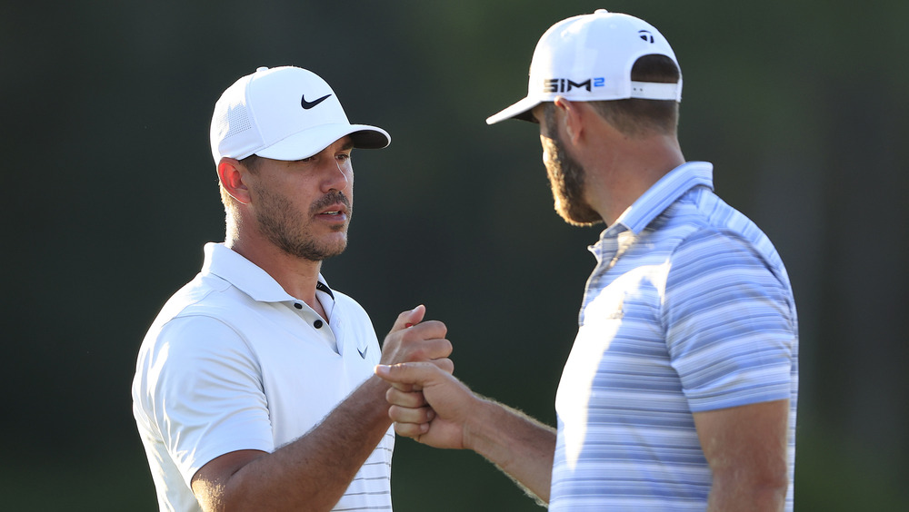 Dustin Johnson and Brooks Koepka fist-bumping