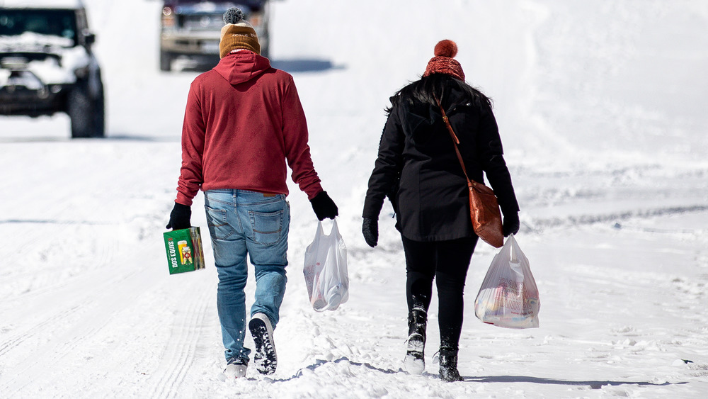 People walk through Winter Storm Uri 