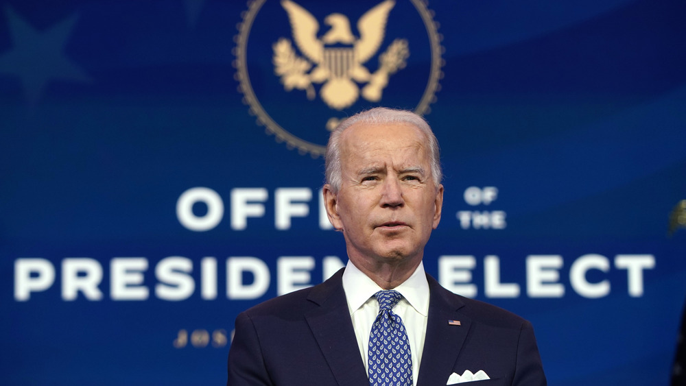 Joe Biden in front of President-Elect sign