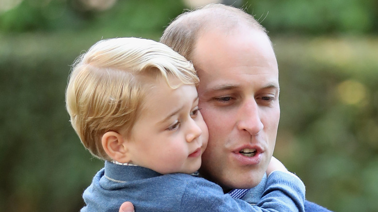 Prince William cuddles his son Prince George