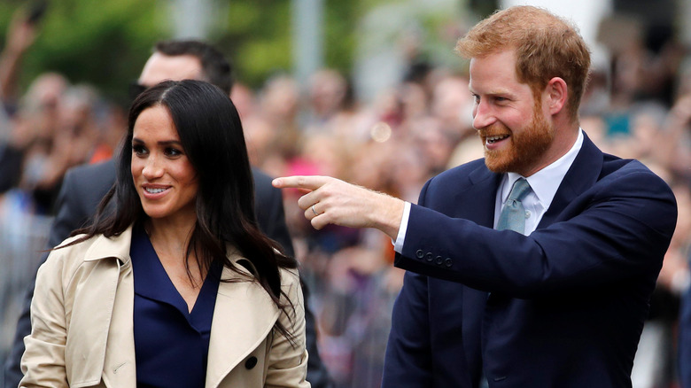 Prince Harry and Meghan Markle greet fans.