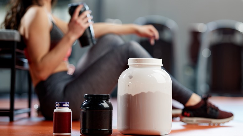 Protein powder and woman with drink