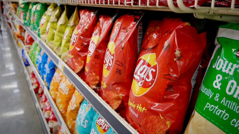 Different brands of potato chips on a store shelf