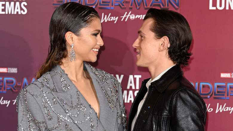 Zendaya and Tom Holland smiling at each other