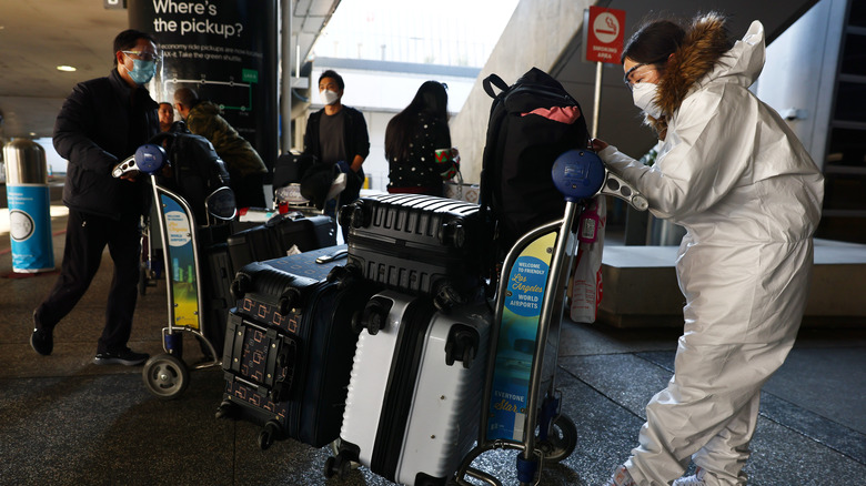 passengers in PPE outside LAX