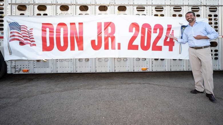 Donald Jr. with banner that reads "Don Jr. 2024"