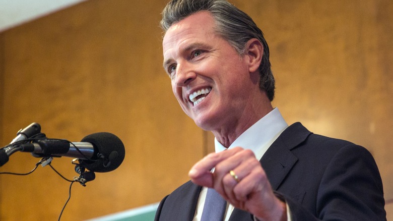 Gavin Newsom speaking into a microphone 