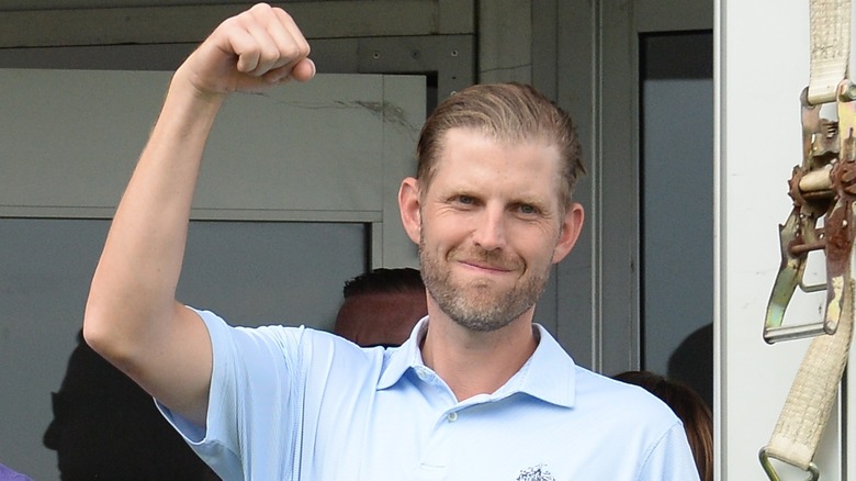 Eric Trump smiling with fist in the air