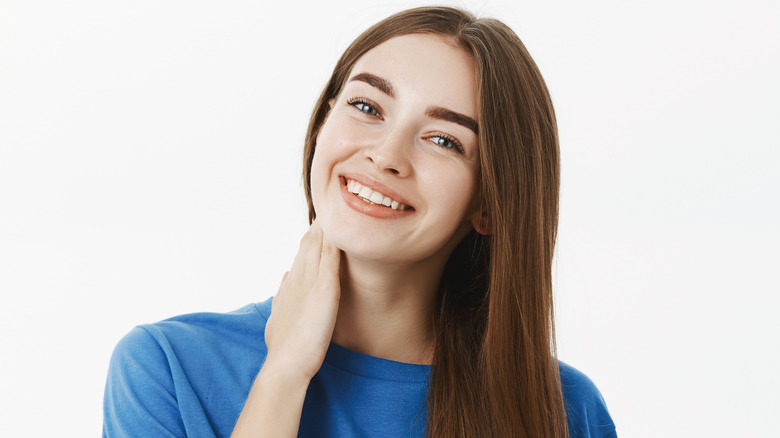 woman smiling with mouth open and head tilted to the side