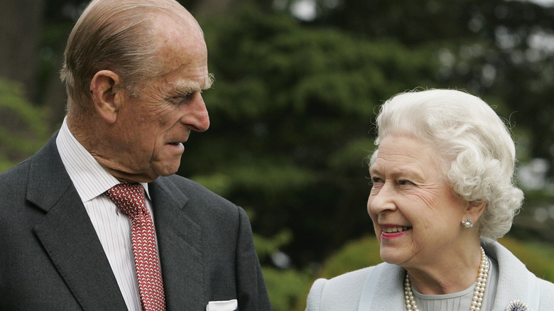 Prince Philip and Queen Elizabeth II smiling at each other