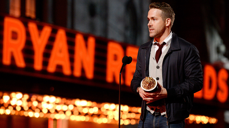 Ryan Reynolds waist-up holding award