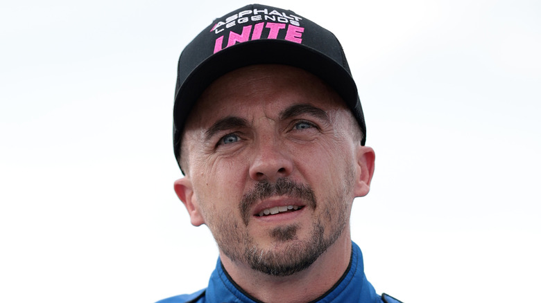 Frankie Muniz posing in race car clothes