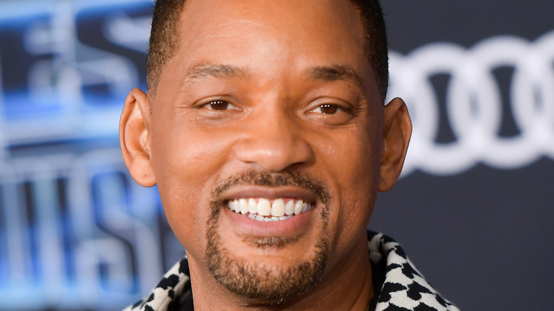 Will Smith smiling widely on the red carpet