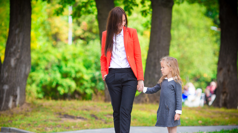 Mother bringing child to school 