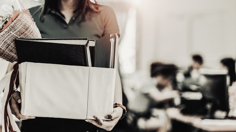 Woman carrying a box out of the office