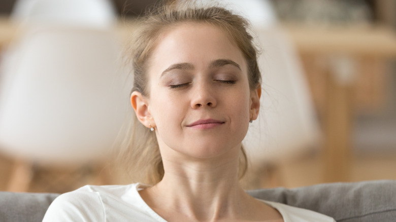 woman sitting with eyes closed