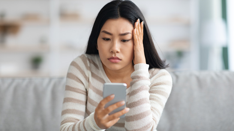 Woman anxiously on her phone