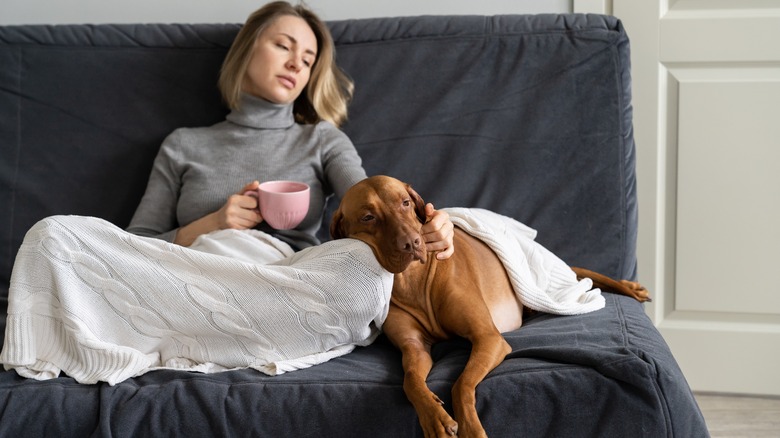 Woman sits with dog