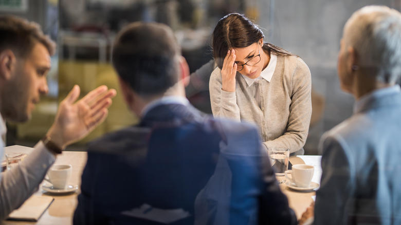 Woman looking down in meeting