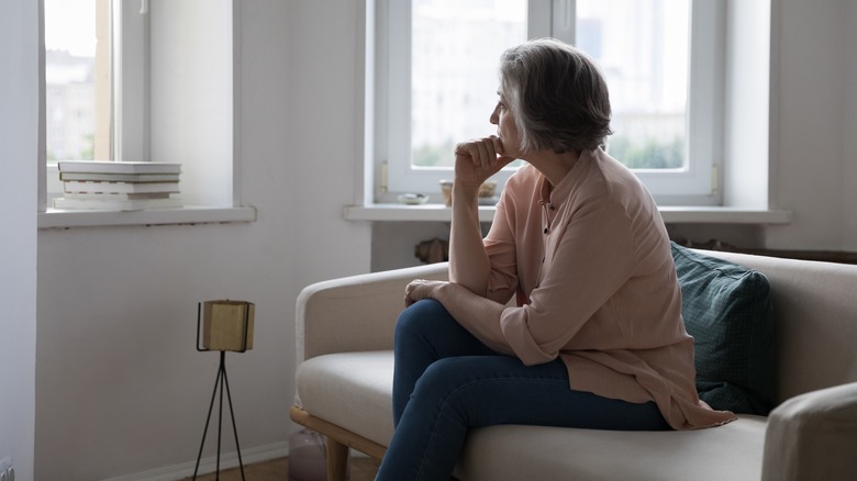 Woman sits alone