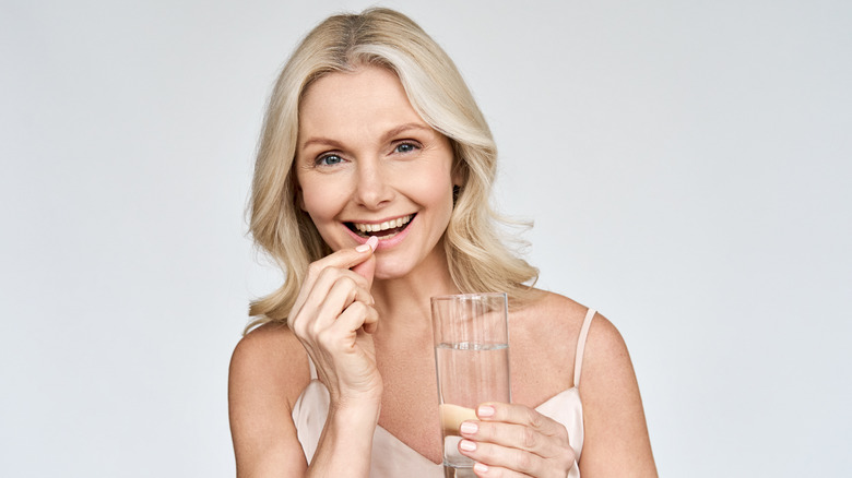 Older woman taking supplement