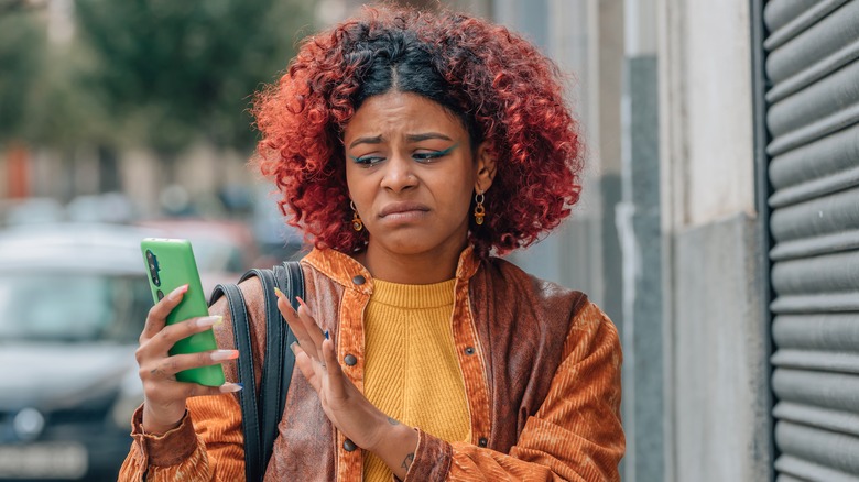 Woman looking unimpressed at her phone