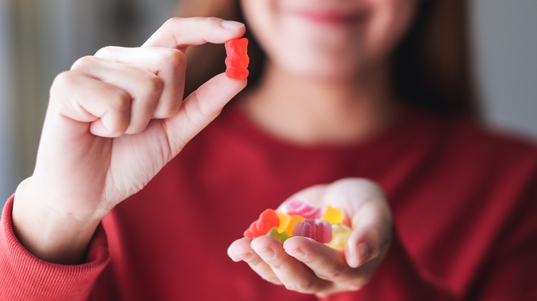 Woman holding up gummy bears