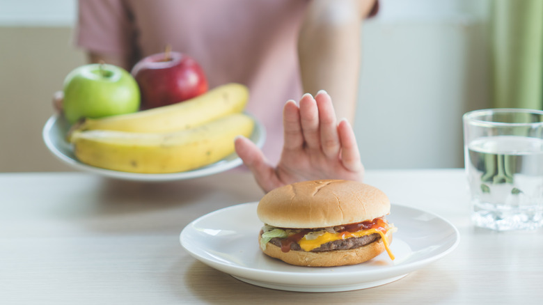 person saying no to a burger