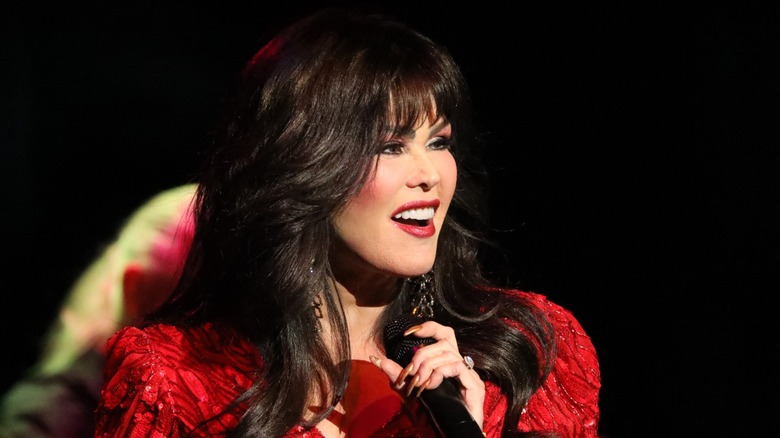 Marie Osmond smiling, holding microphone