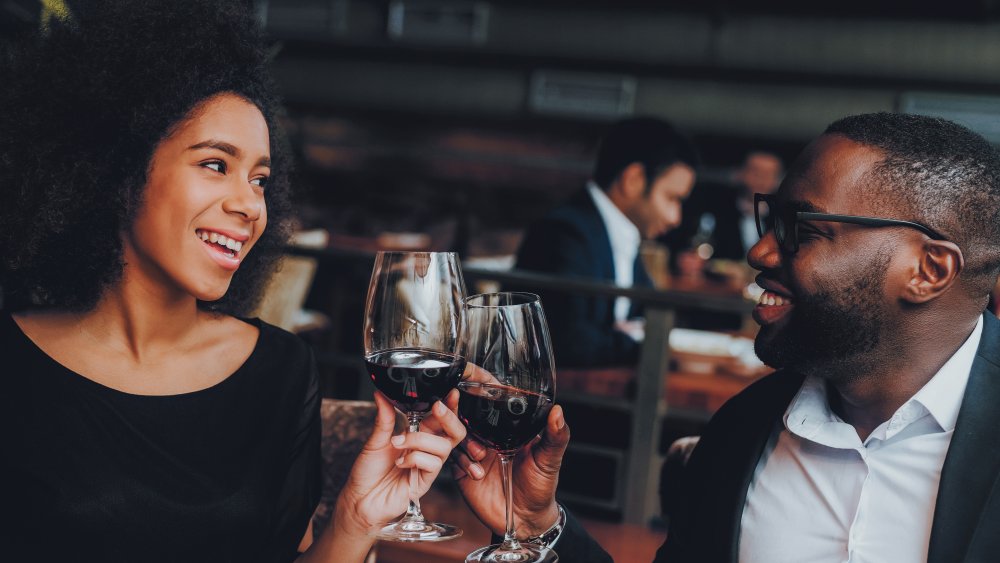 Couple in a restaurant toasting with wine glasses