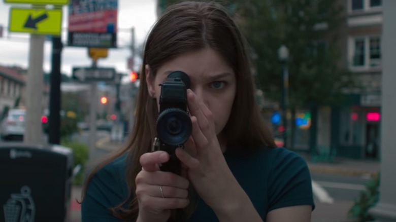 Catharine Daddario with camera to her eye in music video for Wyland's Nowhere Now