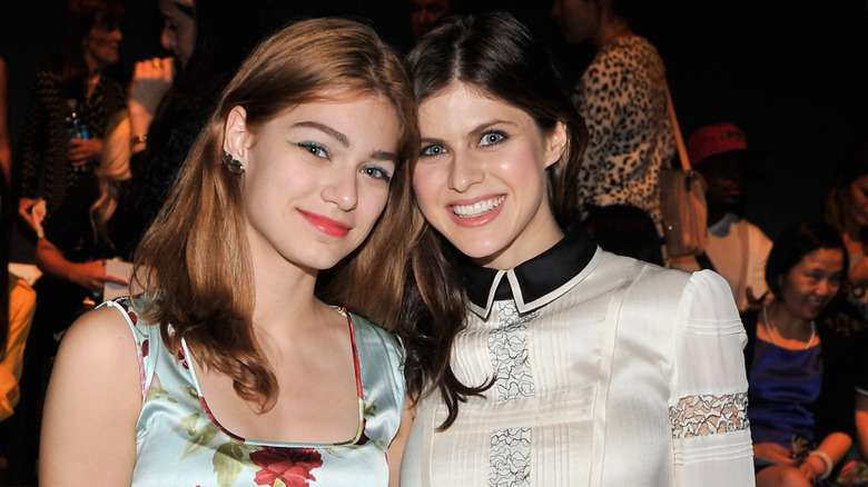 Catharine Daddario posing with sister Alexandra Daddario at 2014 fashion show