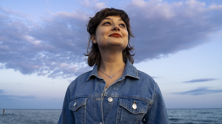 Woman smiles with sky in background