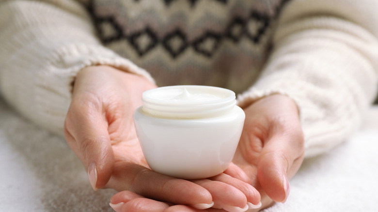 A woman holding cream