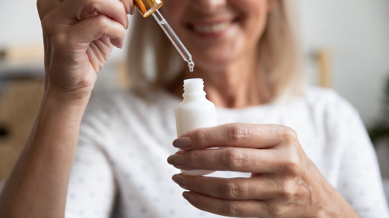 Woman using facial cleansing oil