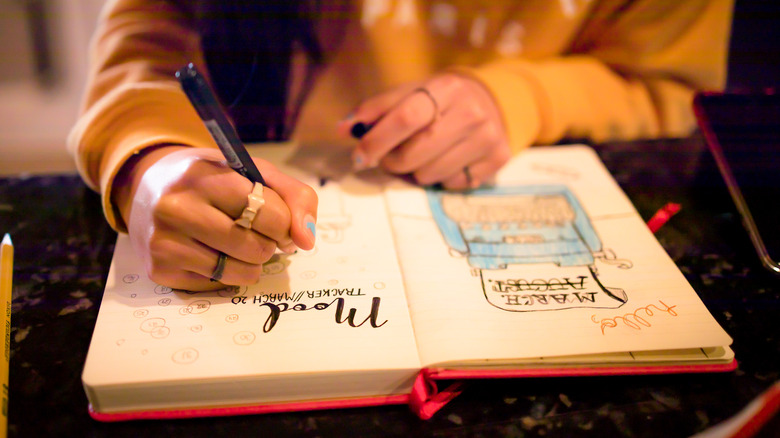 woman with "mood" written in journal